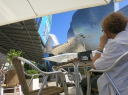 Barb contempating the Guggenheim during lunch