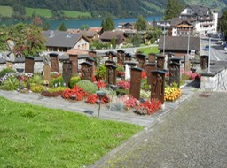 interesting grave "stones" (carved wood)  in front of the Lungern church