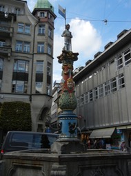 colorful fountain with masks of Herr & Frau Fritsci (restaurant in previous photo)