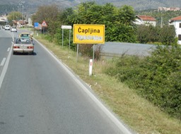 road sign in Bosnia with cyrllic letters painted over